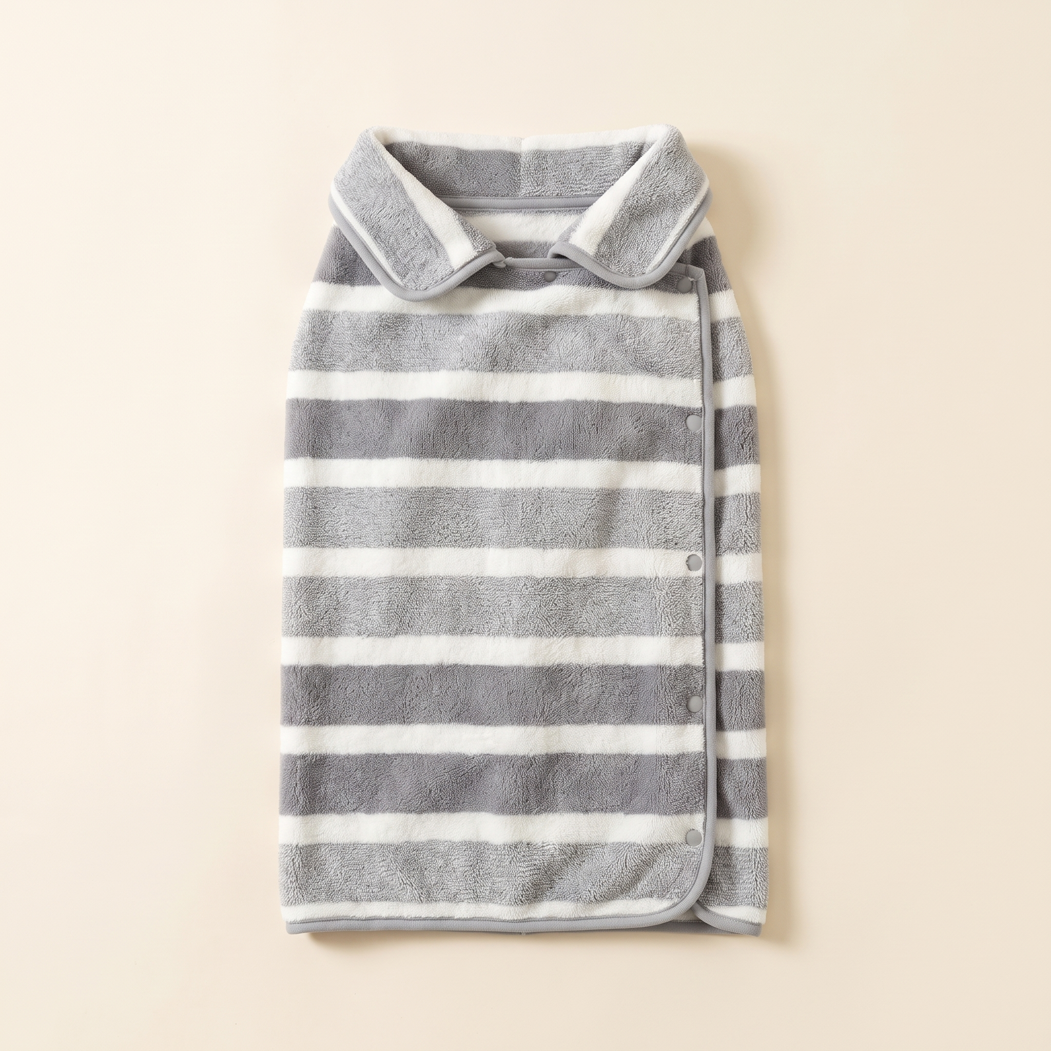 The Wandra Fen Robe in slate stripe, laid flat on a plain cream background showing the collar, bound edges and snap fastenings