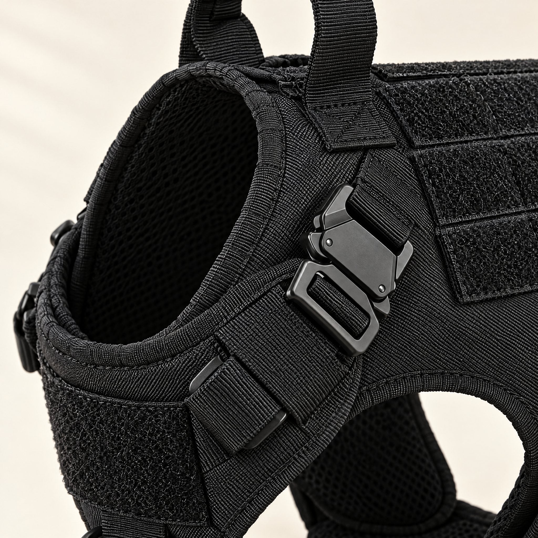 Close-up of the Tor harness metal quick-release neck buckle, adjustable strap and breathable mesh lining